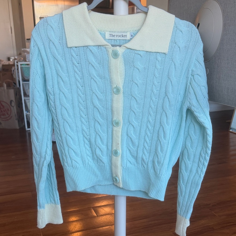 The Rocket Women's Light Blue Cable Knit Button-Up Sweater with Cream Trim